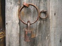 Rusty iron hoop on a beaten old door in the village of Monodendri in Central Zagori