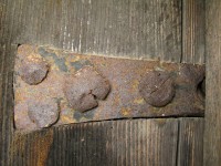 Rusty old traditional iron strap door hinge in the village of Monodendri in the Zagori region of Epirus, Greece