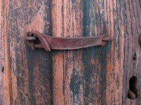 Old and rusty door latch in the village of Kapesovo in Greece