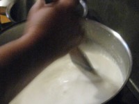 boiling the milk for sanitary reasons and then letting it cool until the finger, when dipped in, feels comfortable