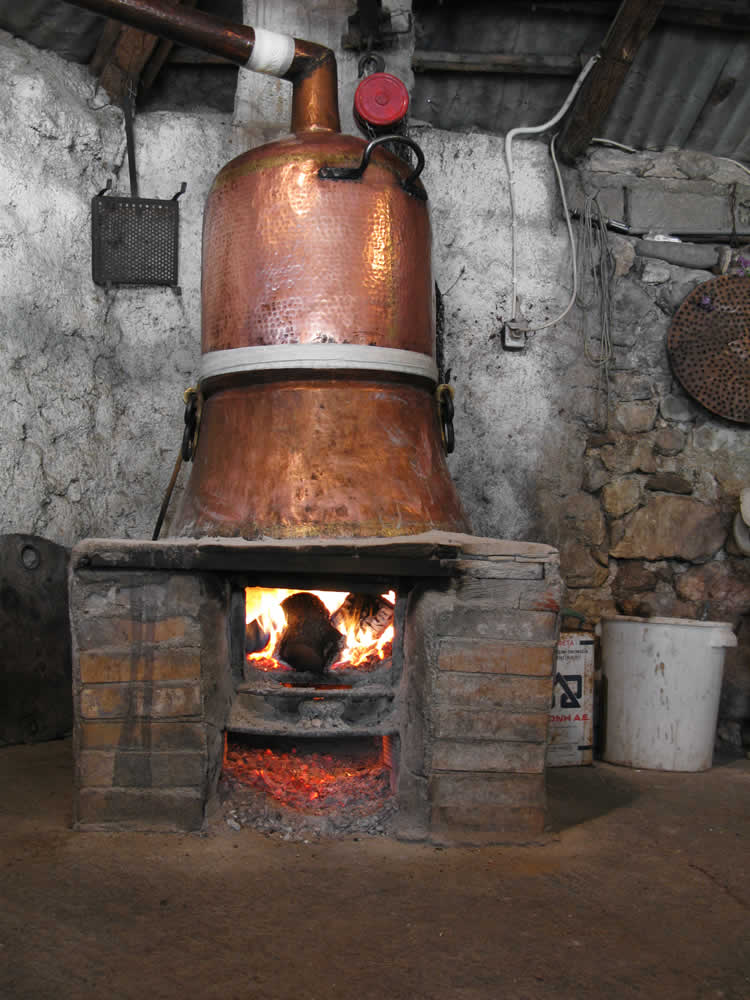 Fire lit with wood heats this very old pot in the Zagori region